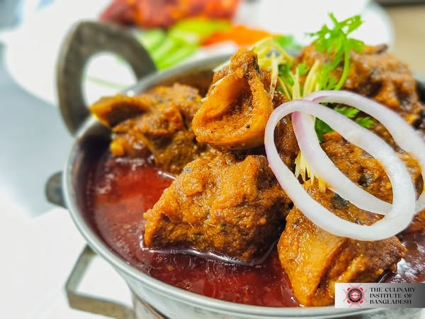 Chef teaching students in a professional kitchen