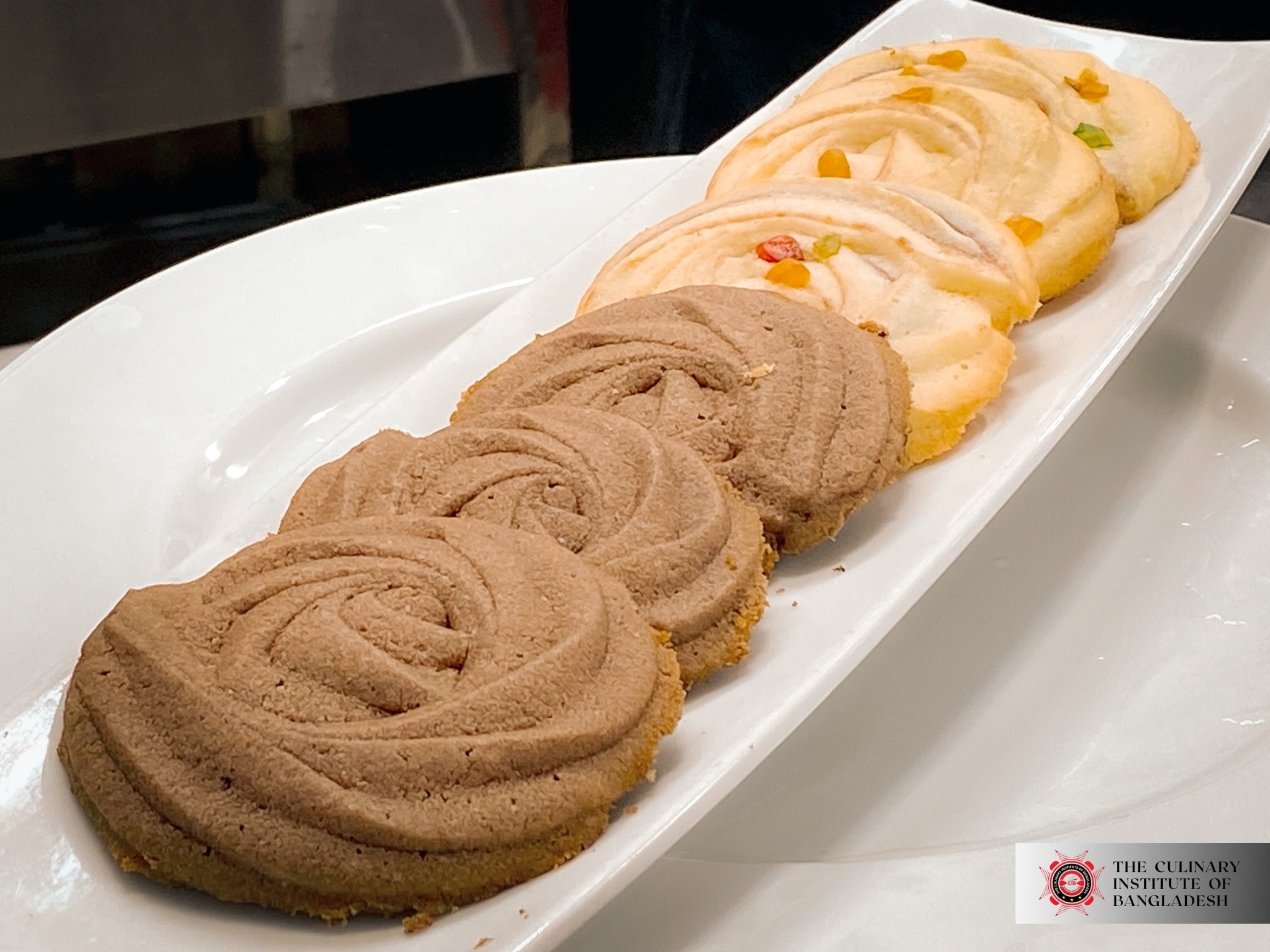 A student meticulously decorating a cake